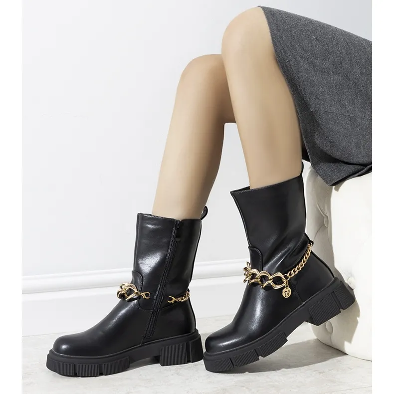 Black insulated boots with a gold Marsha chain